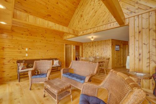 a living room with rocking chairs and a table at Lake Champlain Vacation Rental with Boat Dock! in Melville Landing