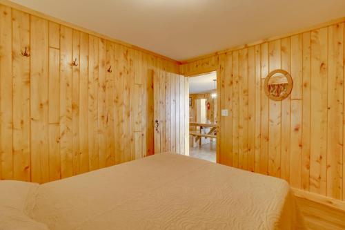 a bedroom with wood paneled walls and a bed at Lake Champlain Vacation Rental with Boat Dock! in Melville Landing