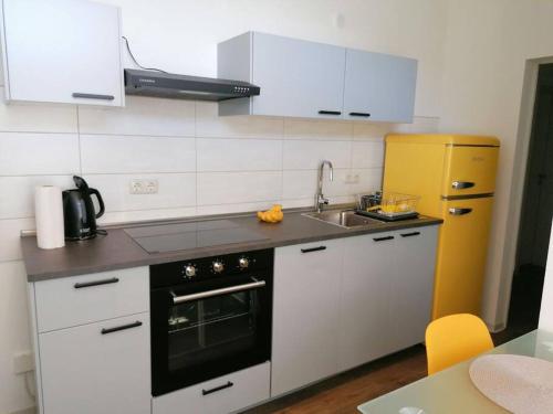 a kitchen with a sink and a stove top oven at cozy City Apartment in Senftenberg