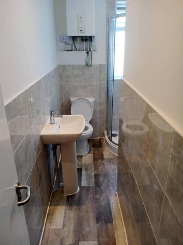 a bathroom with a toilet and a sink and a shower at Double-bed (G2) close to Burnley city centre in Burnley