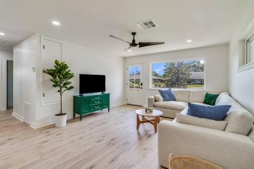 a living room with a couch and a tv at Central Lafayette location w/King Bed & Coffee Bar in Lafayette