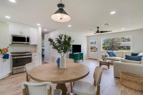 a kitchen and living room with a table and chairs at Central Lafayette location w/King Bed & Coffee Bar in Lafayette
