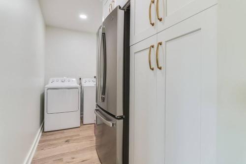 a kitchen with a stainless steel refrigerator and a stove at Central Lafayette location w/King Bed & Coffee Bar in Lafayette