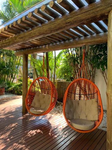 two orange baskets sitting on a wooden deck at Balmare Hotel in Florianópolis