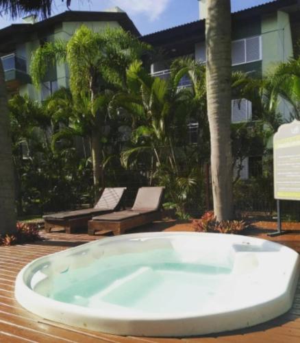 a large bath tub sitting on top of a deck at Balmare Hotel in Florianópolis