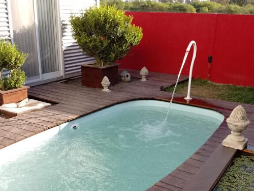 a small pool with a water fountain in a yard at B&B - El Refugio -C D in Paraná