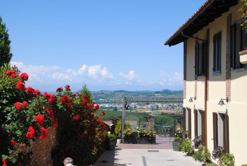 a view from the side of a building with red flowers at Casa Boffa in Barbaresco
