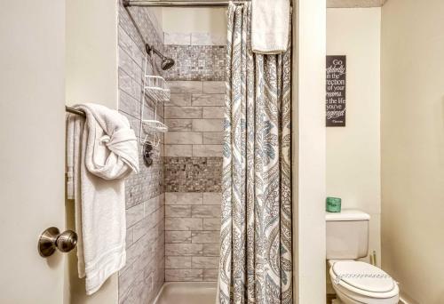 a bathroom with a shower with a toilet at Gatlinburg Mountain Townhome with Pool Access! in Gatlinburg