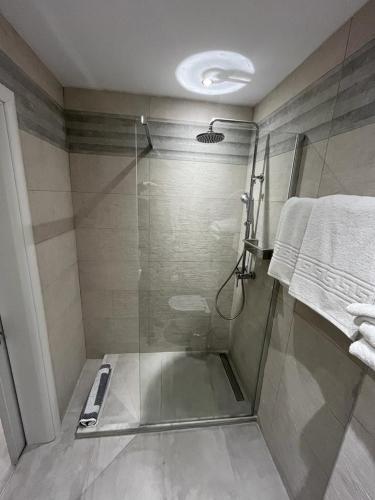 a shower with a glass door in a bathroom at Étoile Glyfada 72 in Glyfada