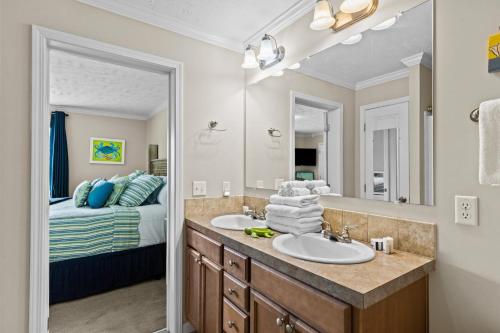 a bathroom with a sink and a bed at Shell Landing Retreat in Beaufort