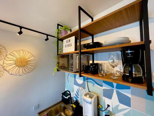 une cuisine avec un évier et un micro-ondes dans l'établissement Studio da fonte/Vista mar, à Salvador