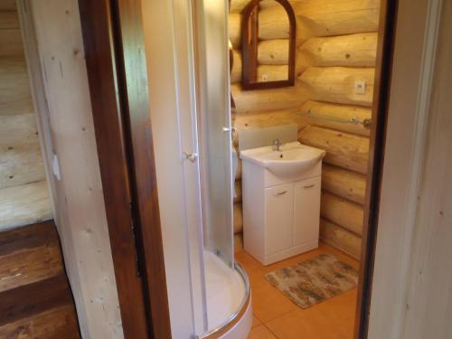 a bathroom with a toilet and a sink at Ubytovanie Koliba Pacho - Zrub Katka in Prievidza