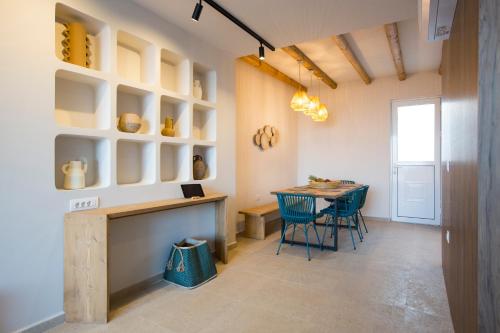 a kitchen and dining room with a table and chairs at Muses of art Villas in Afantou