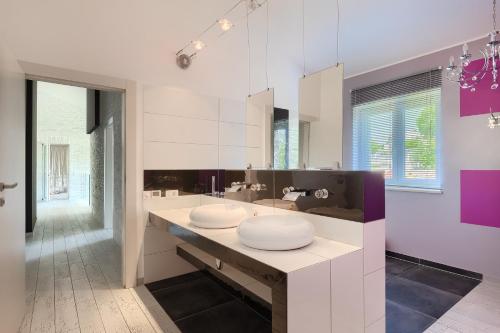 a bathroom with a sink and a large mirror at Complex Barbara in Vižinada