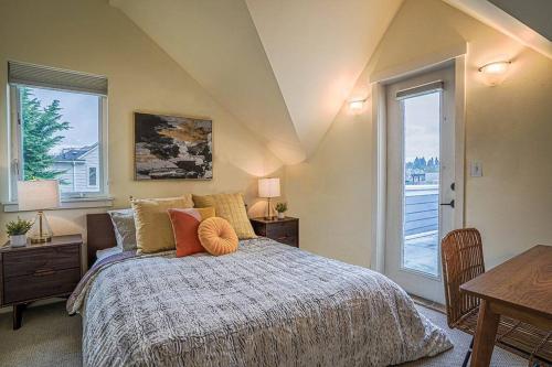 a bedroom with a bed and a table and windows at Fremont's stylish home-Lake Union view on Rooftop in Seattle