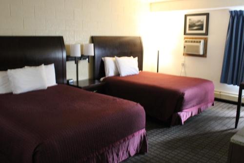 a hotel room with two beds and a window at Aero Inn in Kalispell