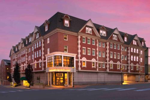 a large red building with a black roof at Portland Harbor Hotel in Portland