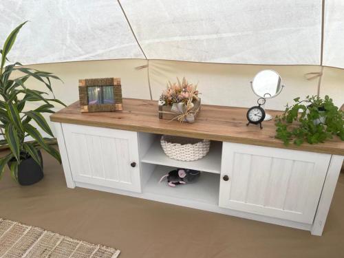 a desk with a wooden counter top in a room with plants at Glamping 4 Acres in Fryšták