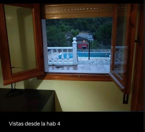 a view of a lighthouse seen through a window at Increíble Casa Rural en la Sierra de Altomira Piscina privada y Barbacoa in Albalate de Zorita