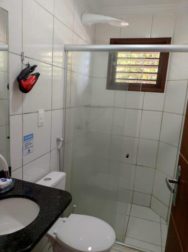 a bathroom with a shower and a toilet and a sink at Rota do Sol Flat in Natal