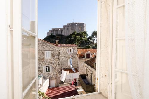 a view from an open window of a city at Rooms Pile in Dubrovnik