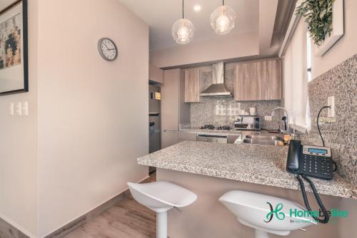 a kitchen with a phone on a counter at Regatta Living II with Breakfast Included! - 502 in Los Prados