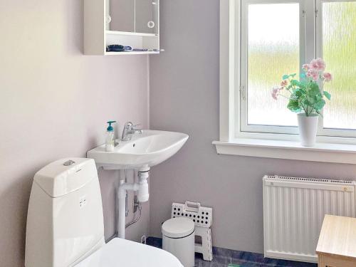 a bathroom with a sink and a toilet and a window at Holiday home Borlänge II in Borlänge