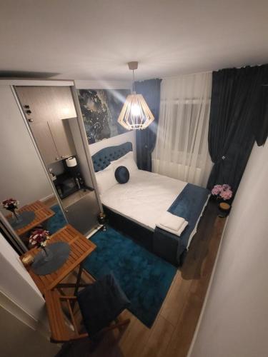 a small bedroom with a bed and a table at District Room in Timişoara
