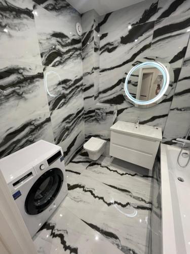 a bathroom with a washer and dryer in it at VIP new apartment Odessa in Odesa