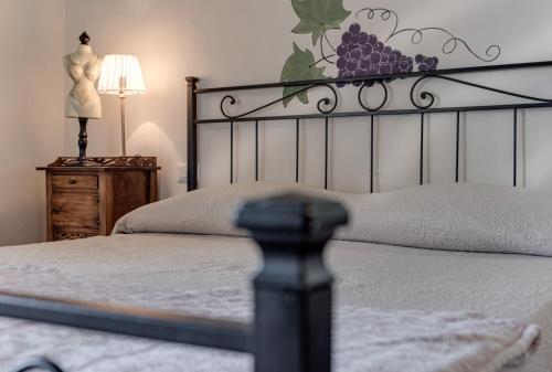 a bedroom with a bed with a black headboard and a table at B&B Le Torri Di Firenze in Fiesole
