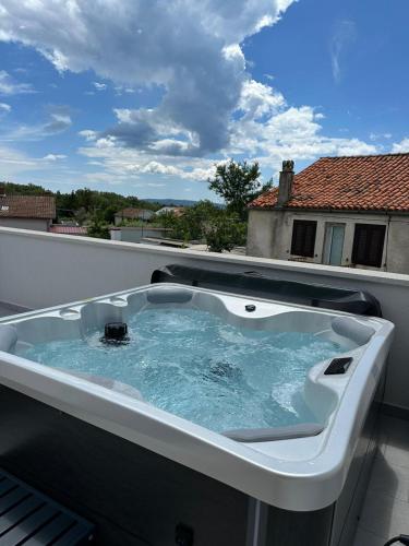 a bath tub sitting on top of a balcony at La Terza in Krk