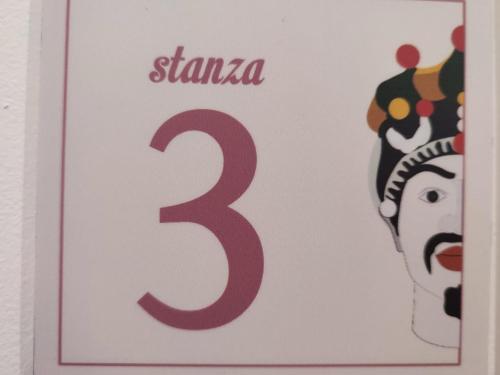 a sign that says stanza with a picture of a man at Siracusa Ortigia by Duomo in Siracusa