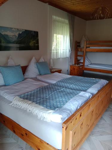 a bedroom with a large bed and two bunk beds at Appartement Landhaus Felsenkeller in Sankt Kanzian