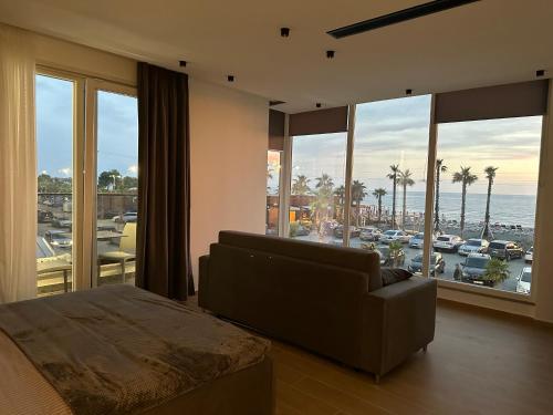 a bedroom with a bed and a view of the ocean at Aral Sea View Apartments & Suites in Shëngjin