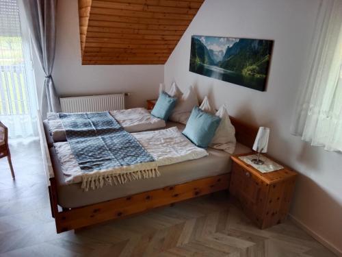 a bedroom with a bed with blue pillows at Appartement Landhaus Felsenkeller in Sankt Kanzian