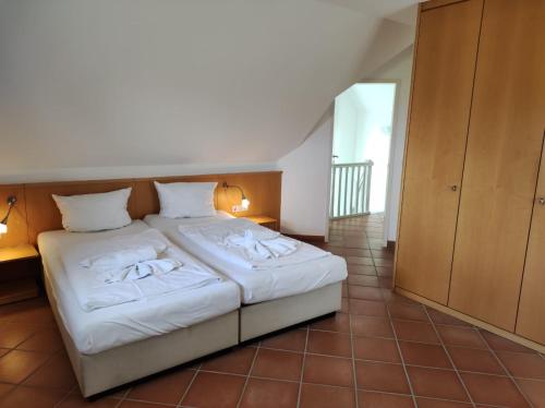 a bedroom with a bed with white sheets and pillows at Ferienhaus Waterkant in Dewichow