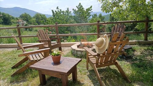 two wooden chairs and a table with a hat on it at Casa Vacanza Contado Latino in Belmonte del Sannio