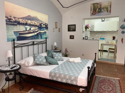 a bedroom with a bed and a painting on the wall at Lazzarella in Naples
