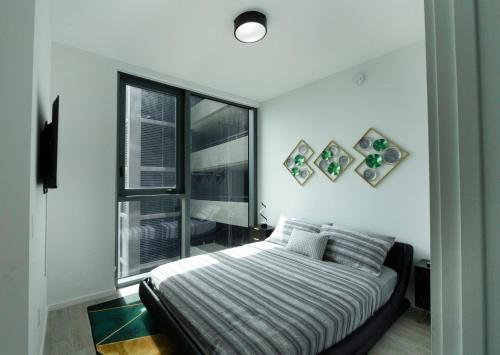 a bedroom with a bed and a large window at Luxury 2'2 apartment brickell downtown in Miami