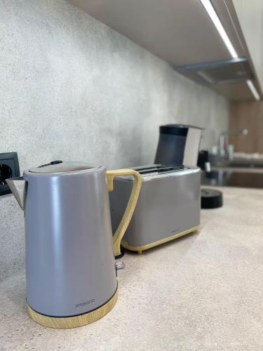 a toaster and a coffee pot on a kitchen counter at Apartment Aliprandi in See