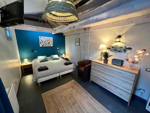 a bedroom with a bed and a couch in a room at Appt 75m2 port St-Martin, parking inclus in Saint-Martin-de-Ré