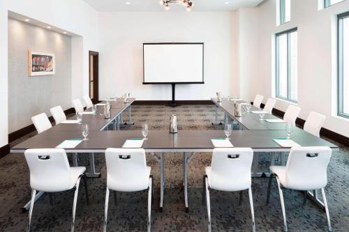 a conference room with a long table and white chairs at Le Meridien Columbus, The Joseph in Columbus