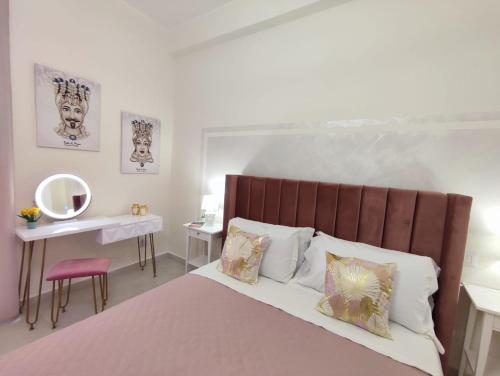 a bedroom with a large bed and a table with a mirror at Siracusa Ortigia by Duomo in Siracusa