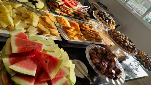 a table topped with lots of different types of food at Balmare Hotel in Florianópolis