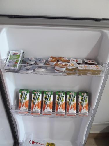 an open refrigerator filled with food and drinks at Depto Laguna Encantada in Ushuaia