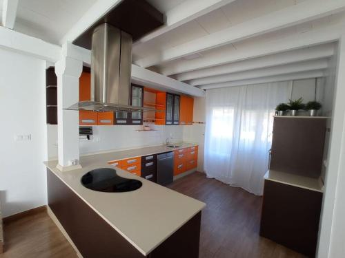 a kitchen with orange cabinets and a white counter top at La casa de Cristina in El Dueso