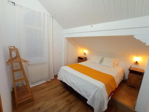a bedroom with a bed with a ladder in it at La casa de Cristina in El Dueso