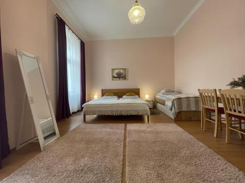 a bedroom with two beds and a mirror at Anzio apartments in Mariánské Lázně