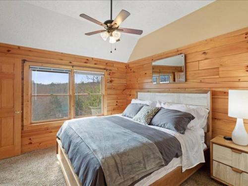 a bedroom with a bed and a ceiling fan at Breathtaking views of the Smokies, 3 mins to Gatlinburg in Gatlinburg