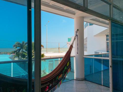 a hammock on a balcony with a view of the ocean at Hotel Abi Inn By GEH Suites in Cartagena de Indias